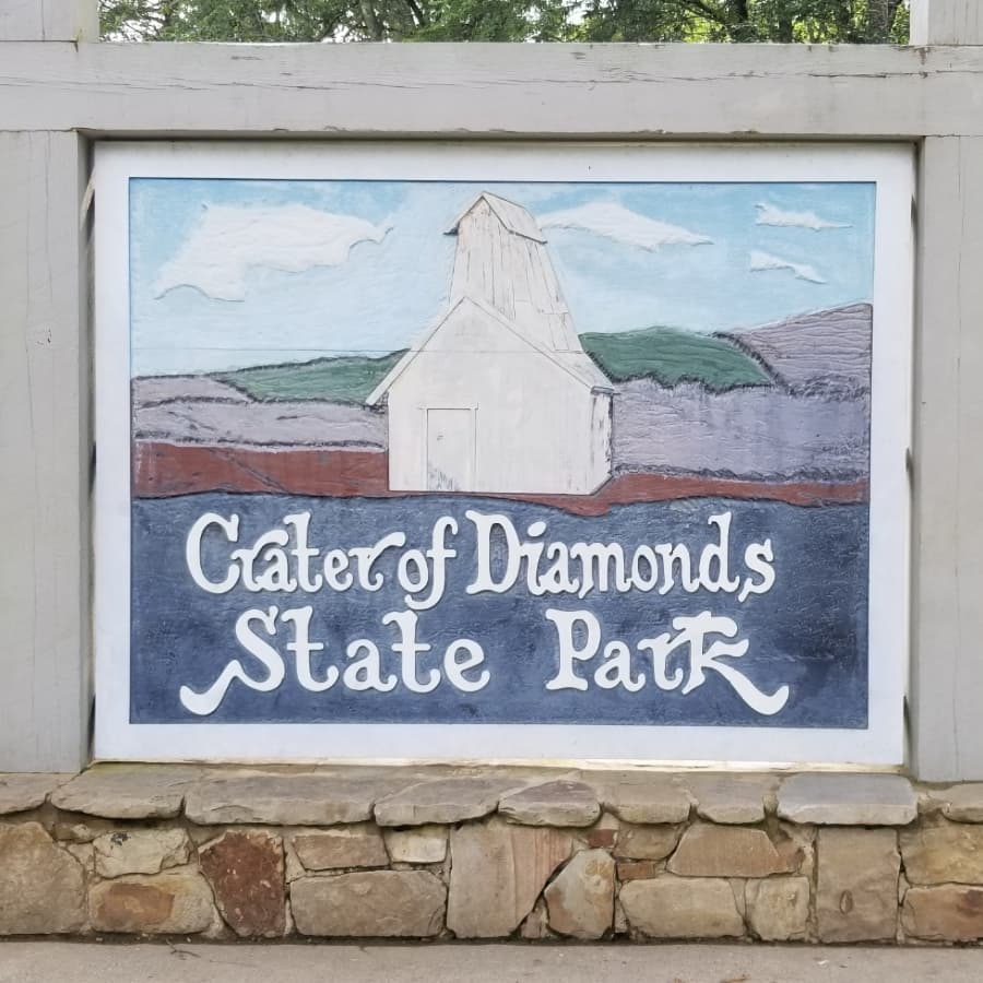 Wooded painted sign that reads "Crater of Diamonds State Park"