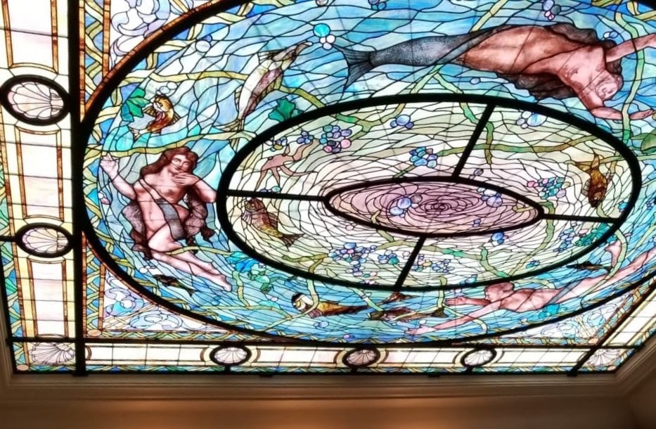 stained glass ceiling depicting 2 mermaids and fish