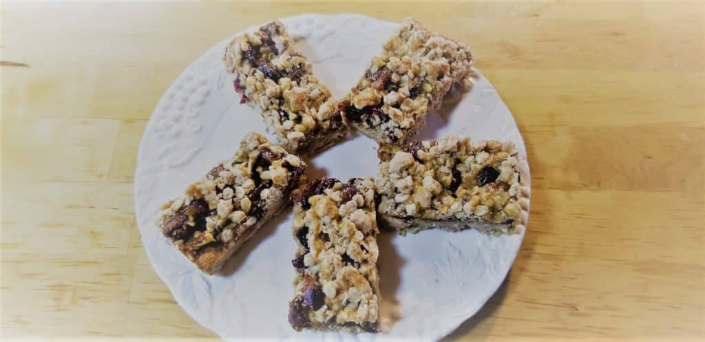 5 cranberry energy bars placed on a white plate