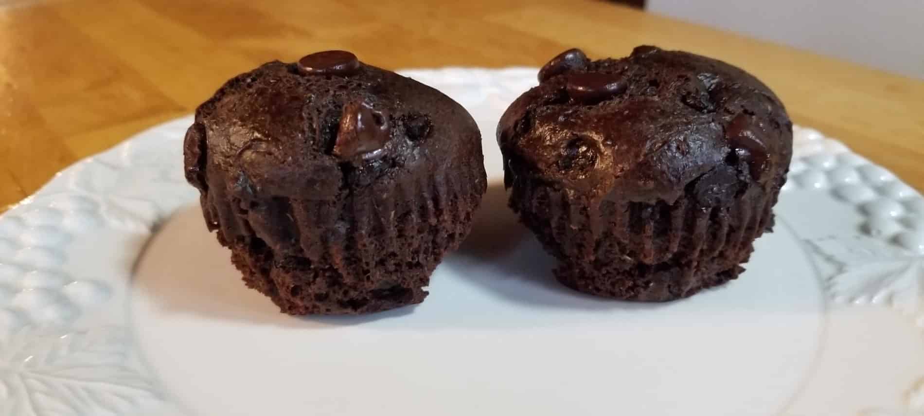 2 choclate muffins on a white plate